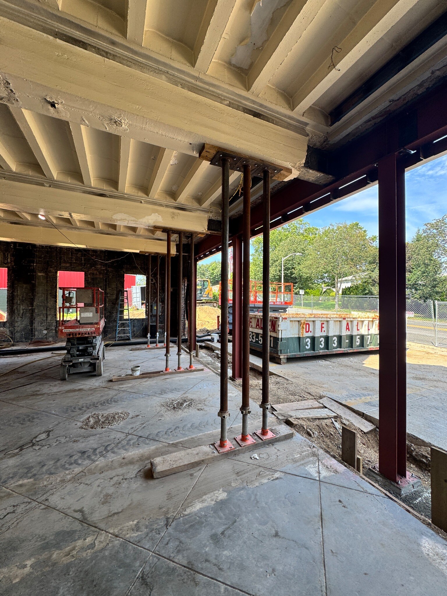 Interior construction at Garden City Firehouse showing temporary shoring and new structural steel
